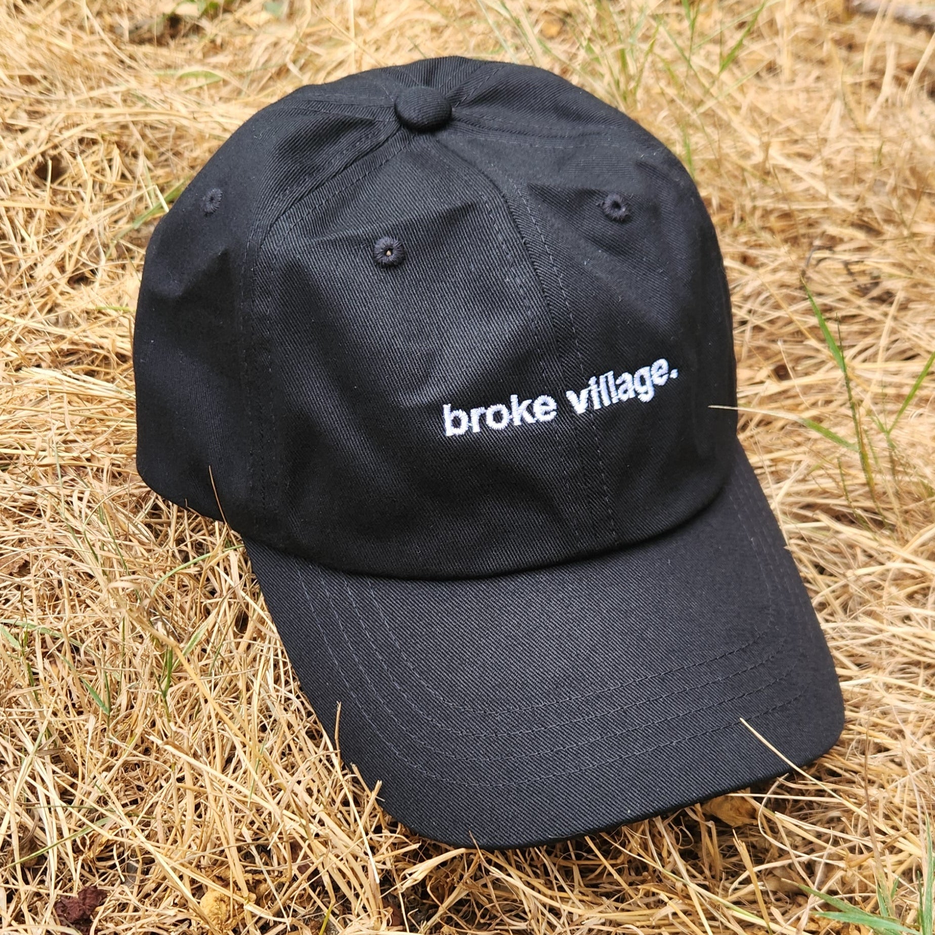 black hat on dead grass