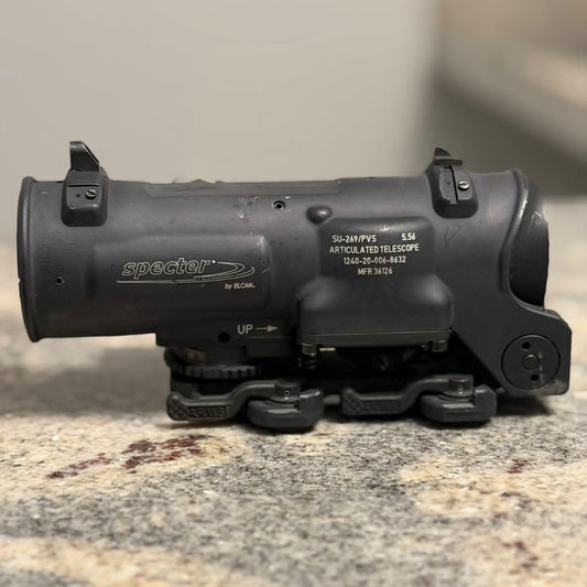 A black Specter 50mm 5Wx LED Artillary Telescope mounted on a black bipod, resting on a speckled granite countertop.