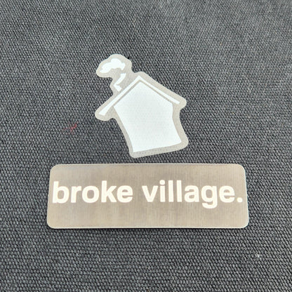 Label with 'broke village' text on a textured surface
